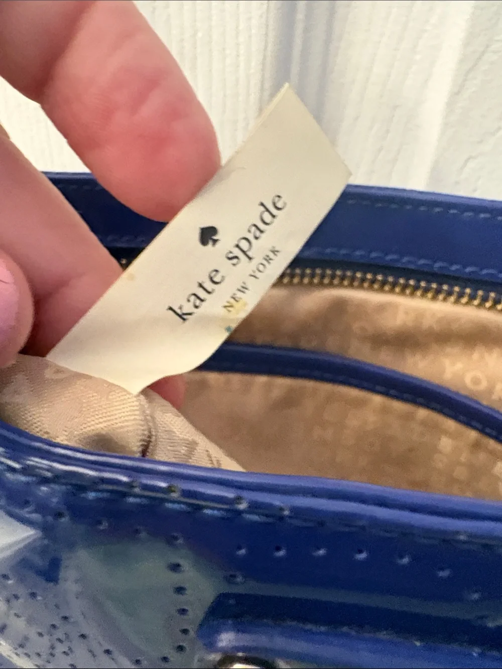 Kate Spade heart perforated patent leather crossbody in cobalt blue.